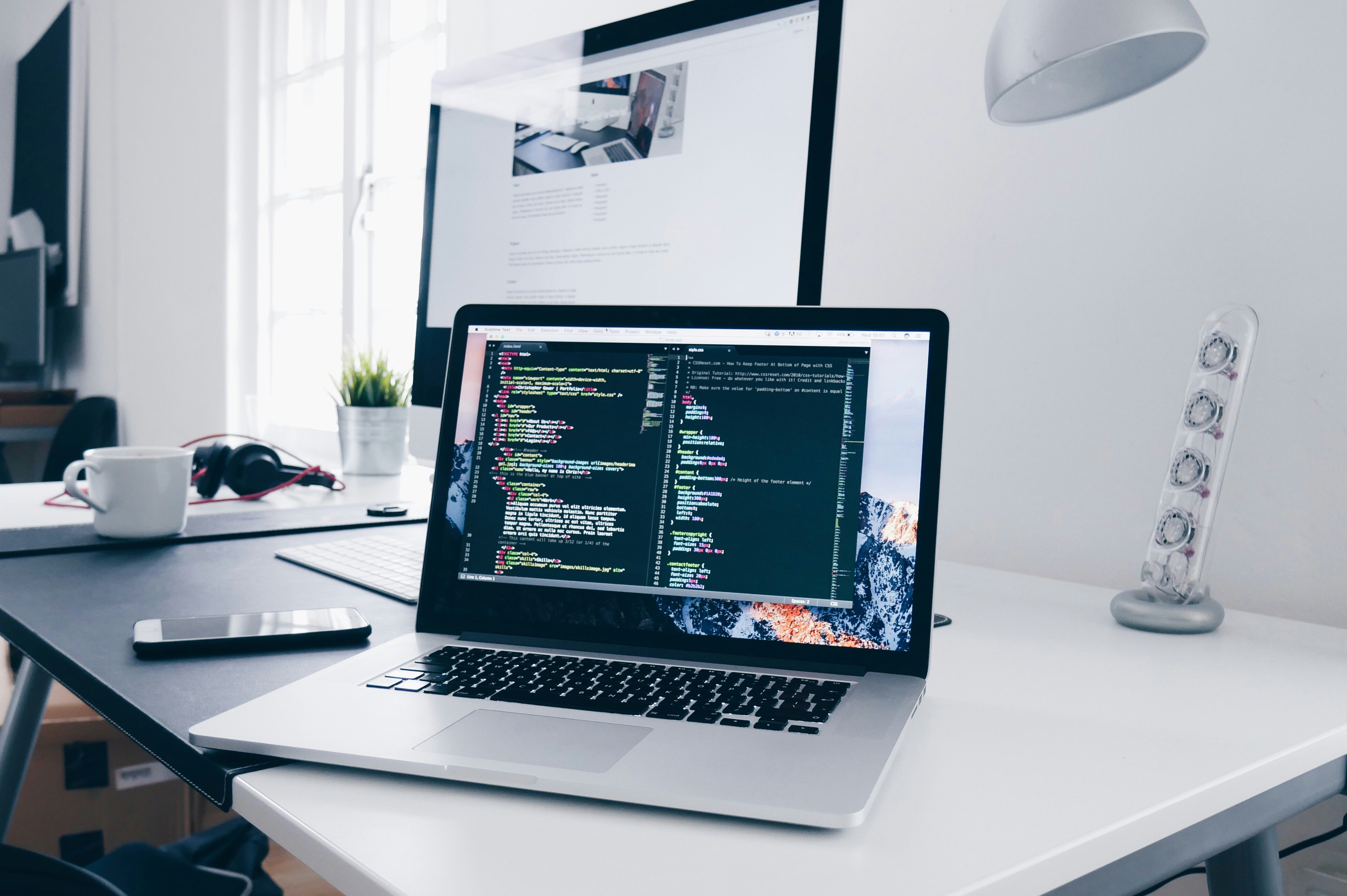 Modern workspace with code editor and analytics dashboard - Photo by Christopher Gower
